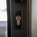 Close-up of a steel door keyhole and lock for inspecting front-door security