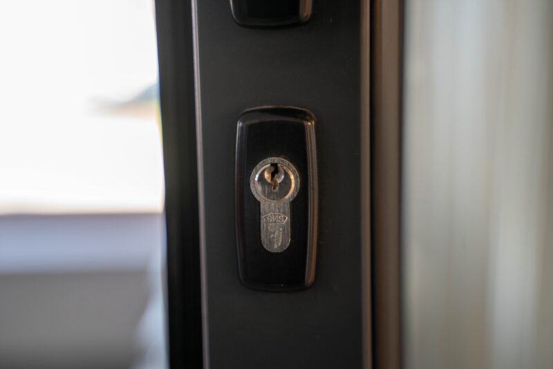 Close-up of a steel door keyhole and lock for inspecting front-door security